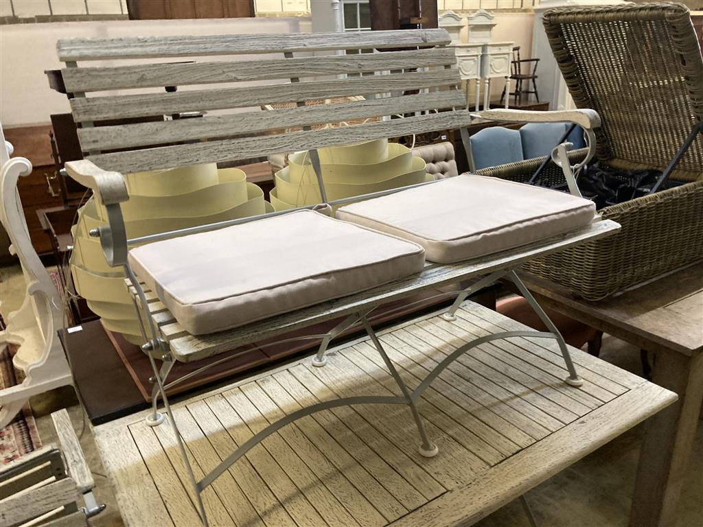 A modern painted slatted wood and metal garden suite of folding table, width 120cm, depth 72cm, height 75cm, bench and a pair of elbow